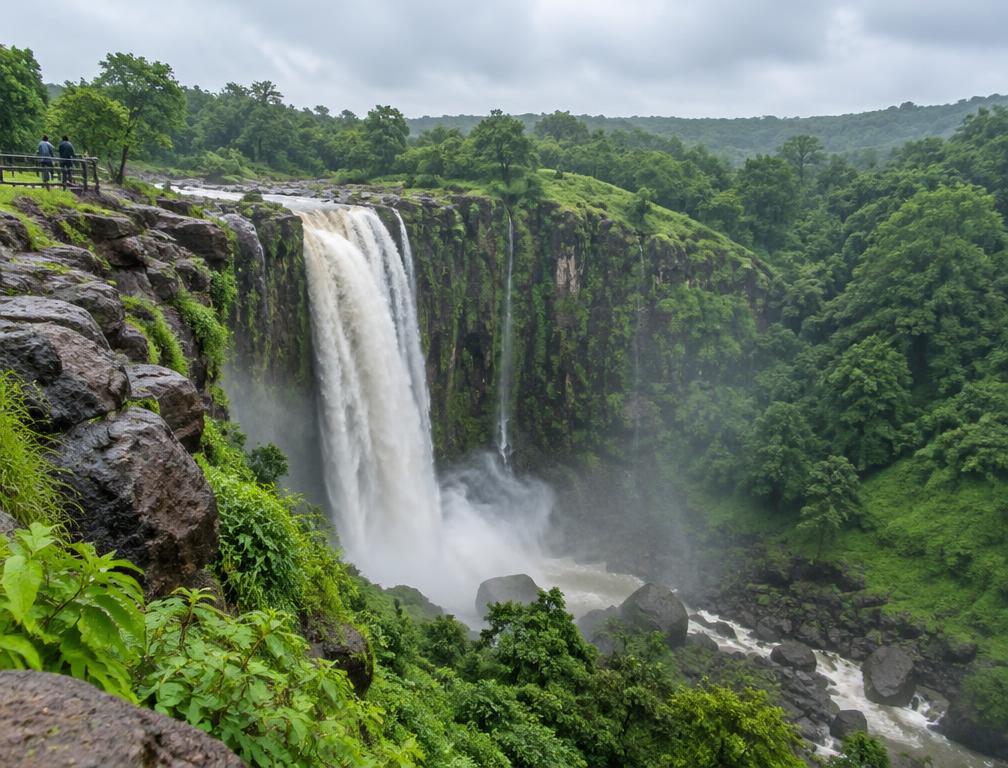 Waterfall tumbling through a green Patalpani ravine